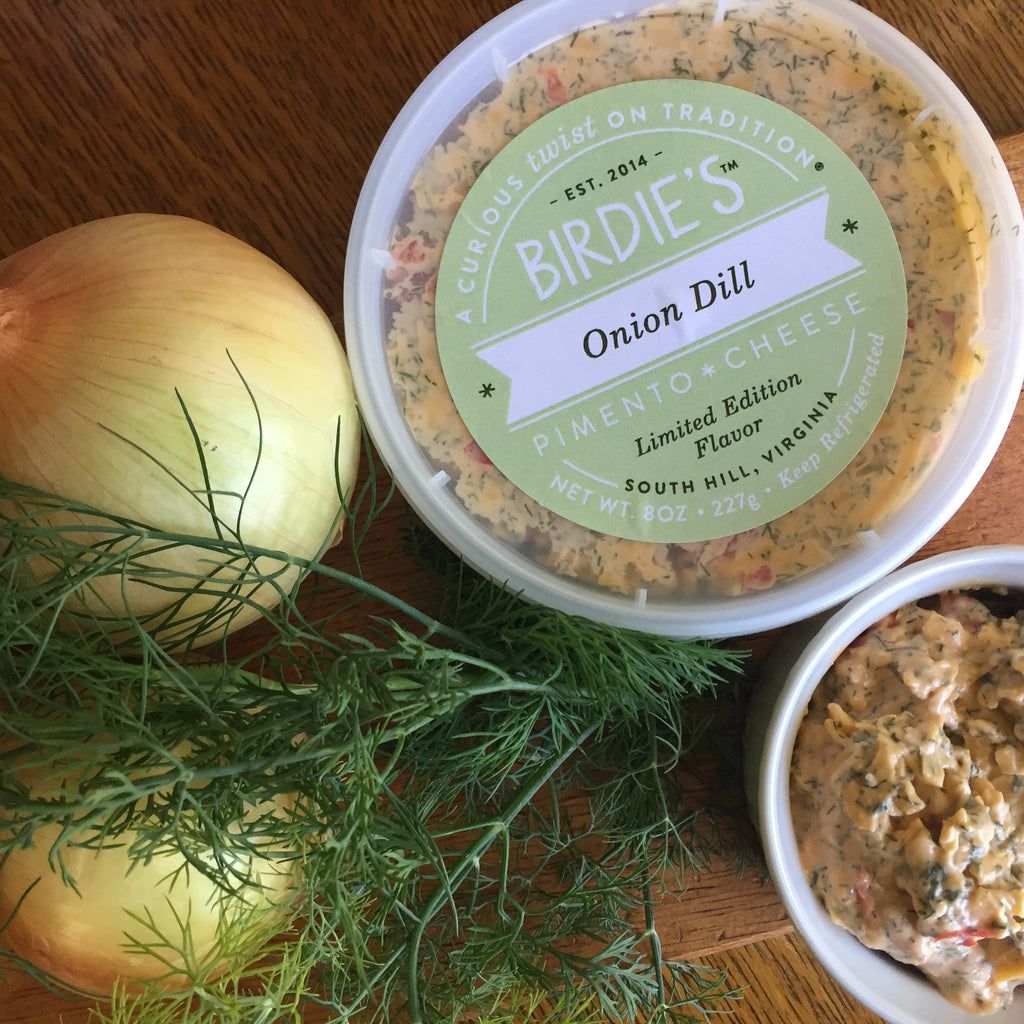 Tubs of Birdie's Onion Dill pimento cheese with an onion and fresh dill